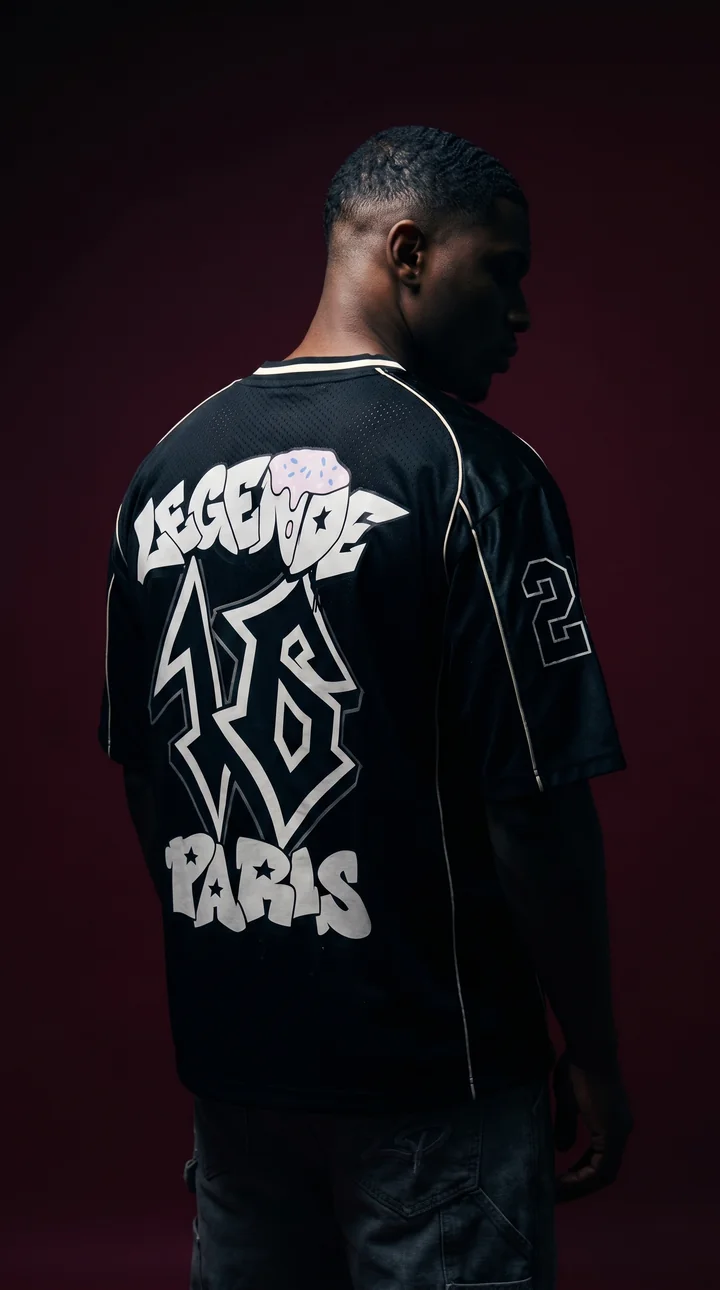 The back of a black Légende Paris graphic jersey against a burgundy backdrop